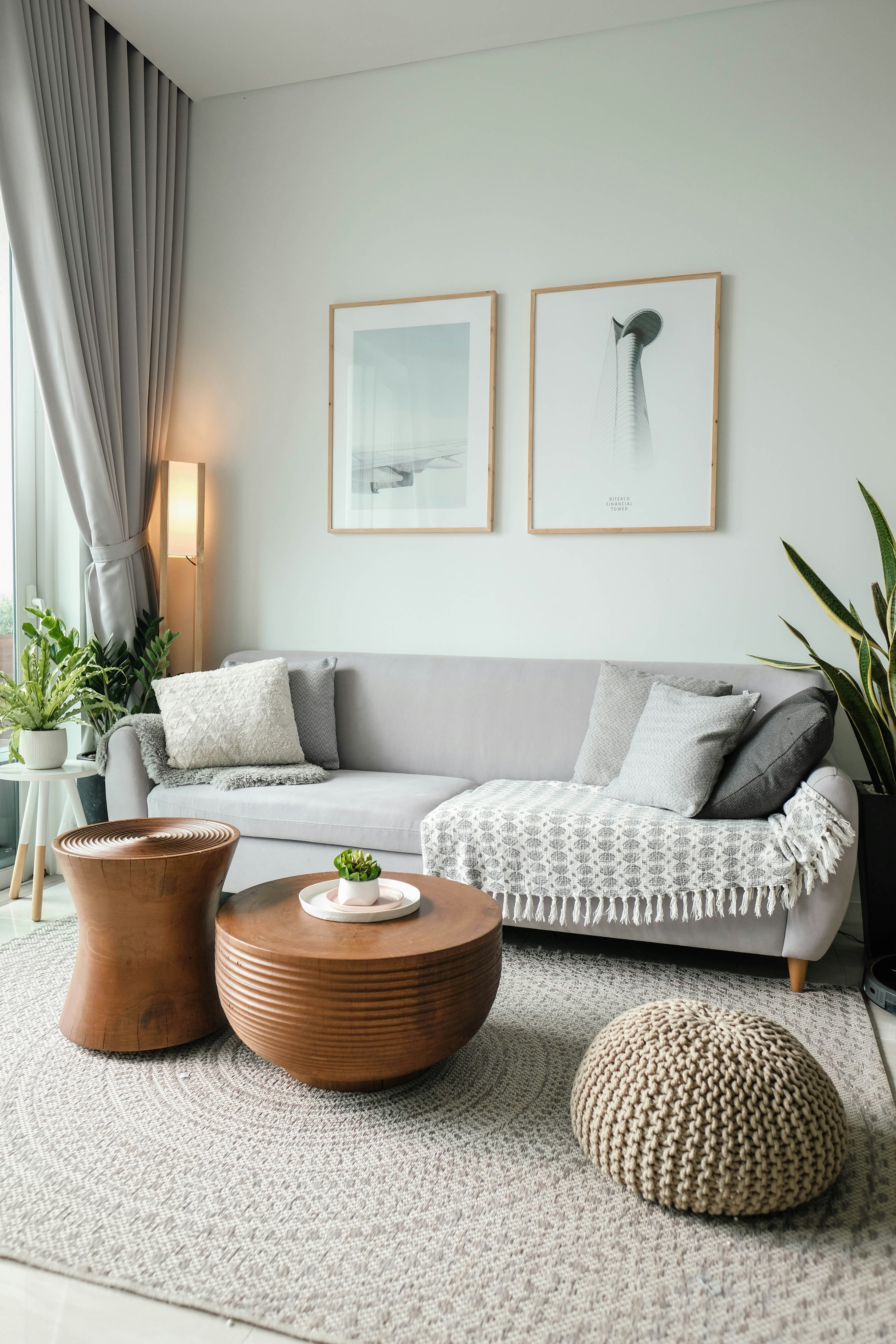 Modern living room with gray sofa, wooden coffee table, and wall art