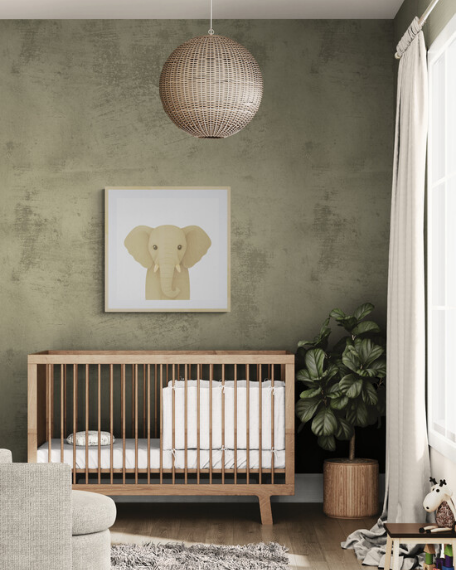 Nursery room with wooden crib, green wall, and a framed illustration of an elephant