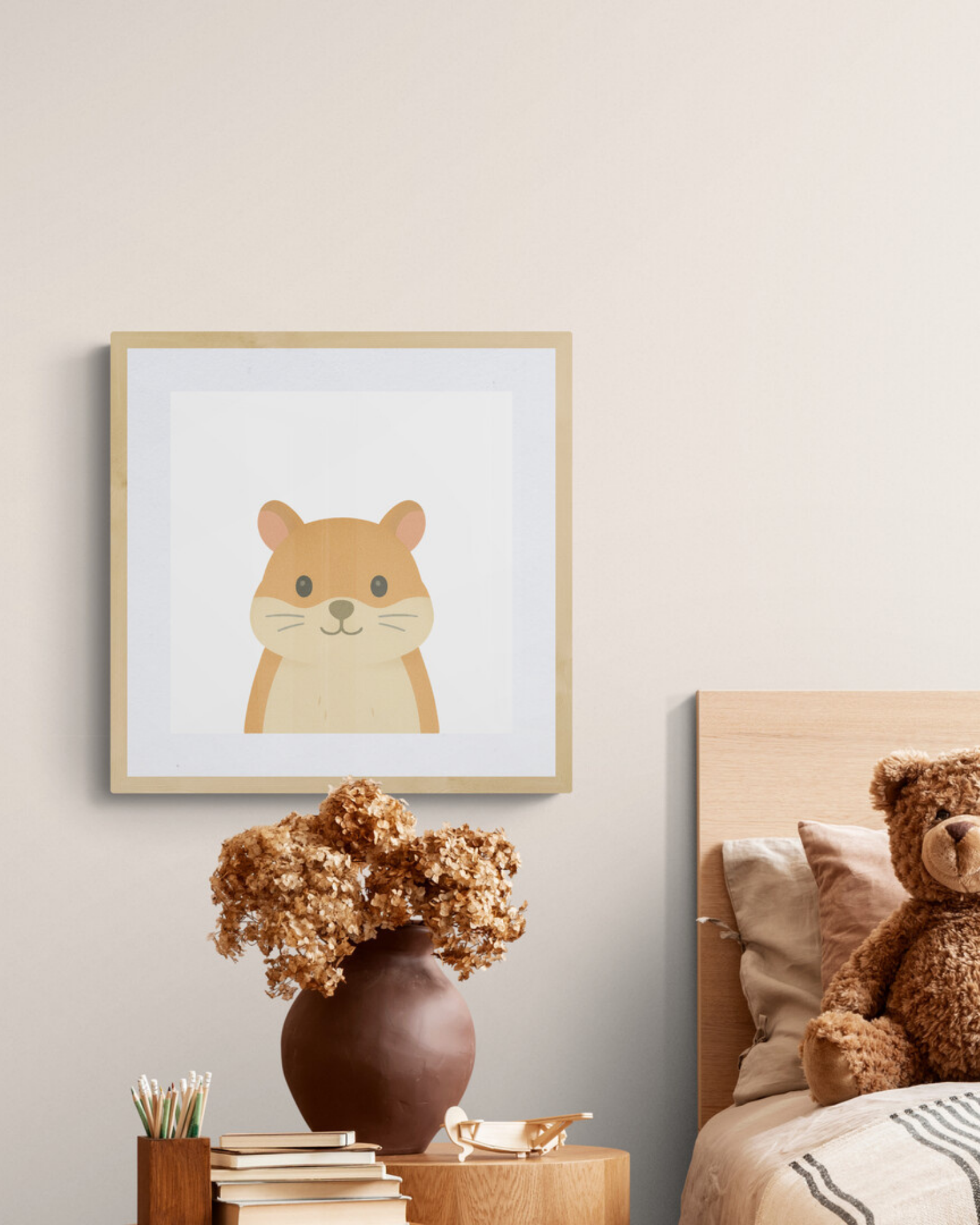 Framed illustration of a hamster on a wall above a bedside table with a vase and books, next to a bed with a teddy bear.