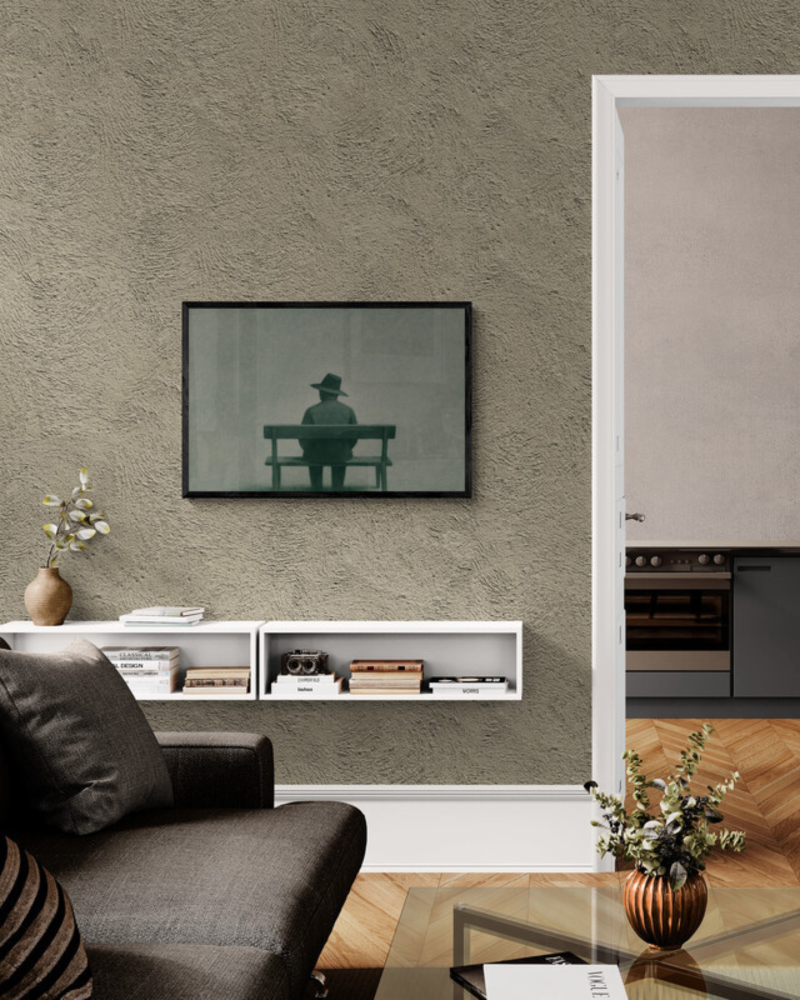 Living room with a gray sofa, coffee table, and wall art of a man on a bench.