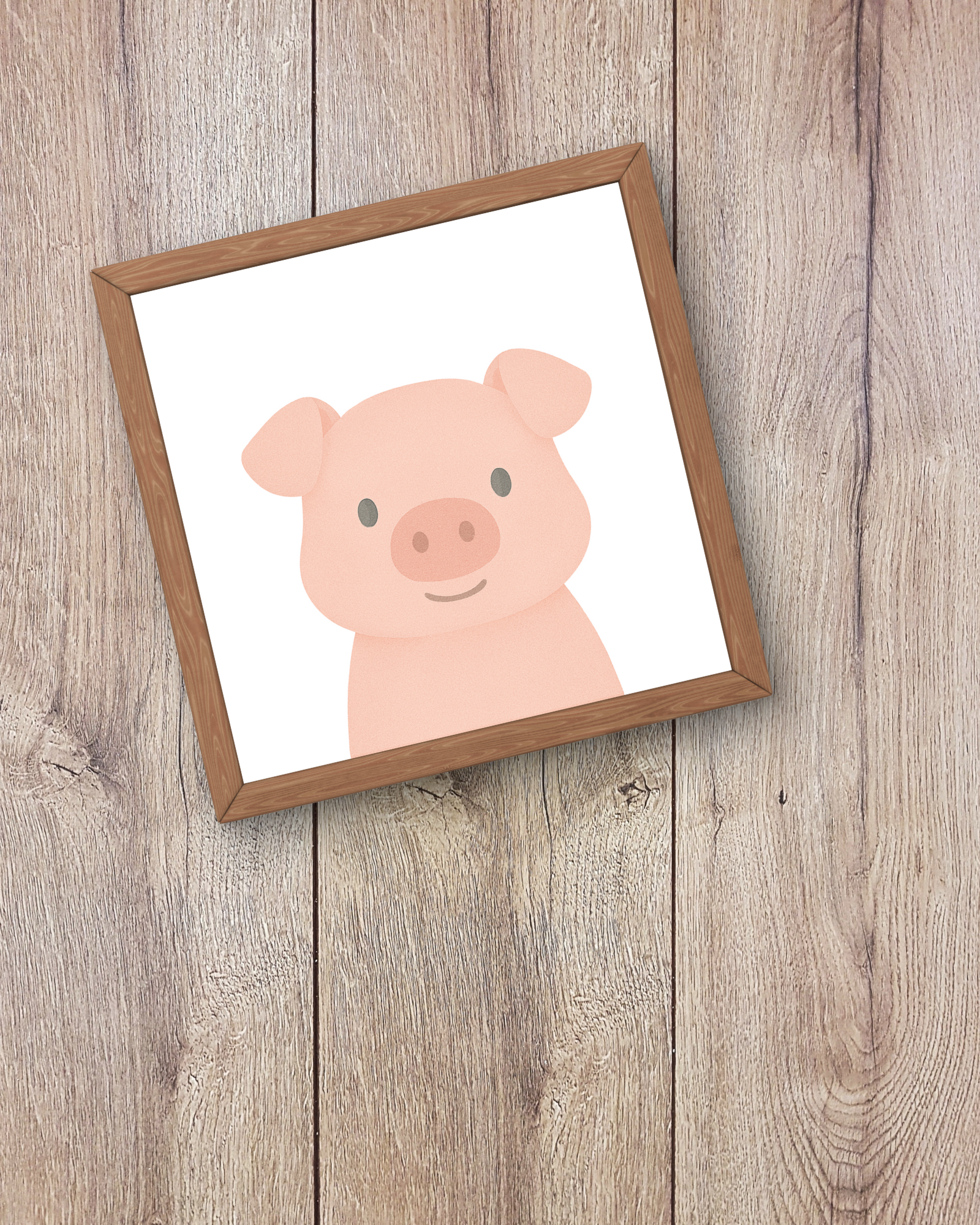 Framed illustration of a pink pig on a wooden surface